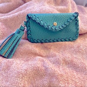 Small turquoise wallet with tassel.